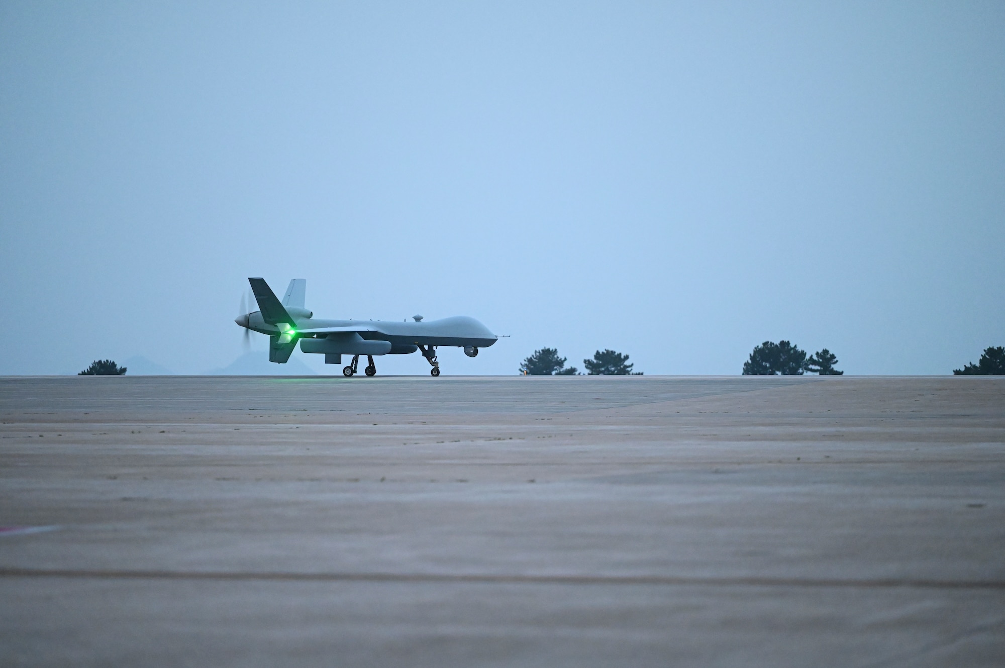 An MQ-9 Reaper taxis across the runway after arriving to support exercise Freedom Flag 25-1 at Kunsan Air Base, Republic of Korea, April 17, 2025.