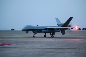 An MQ-9 Reaper taxis across the runway after arriving to support exercise Freedom Flag 25-1 at Kunsan Air Base, Republic of Korea, April 17, 2025.