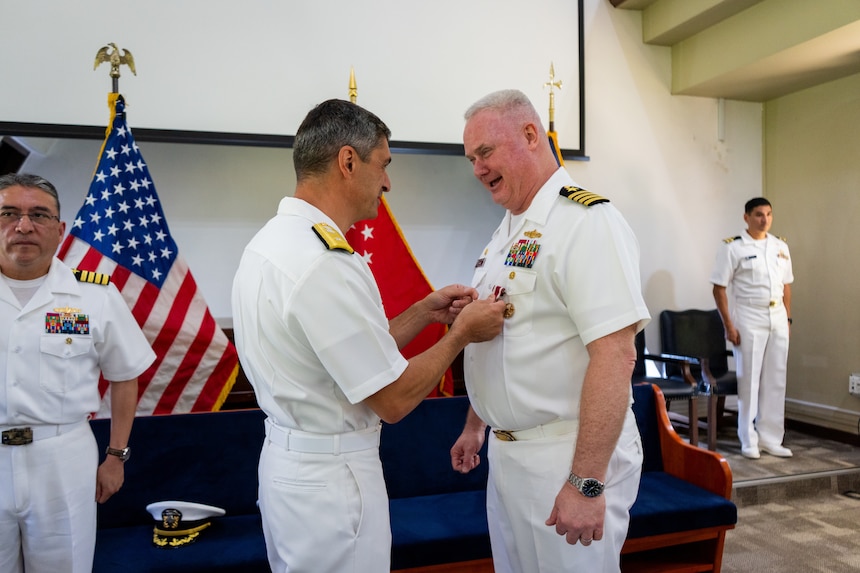 Rear Adm. Todd F. Cimicata, Commander, Logistics Group Western Pacific/ Task Force 73, presents Capt. Robert R. Williams, outgoing commander, Military Sealift Command Far East, with the Legion of Merit medal during a change of command ceremony at the Singapore Naval Installation in Sembawang, April 30, 2025, recognizing his achievements over the past two and a half years as Commodore of MSC Far East.