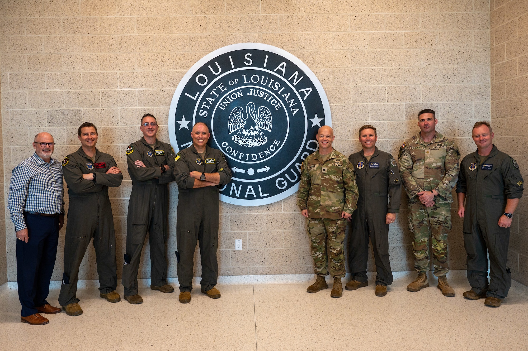 Leadership from the 2nd Bomb Wing, 159th Fighter Wing, Louisiana National Guard and Chennault International Airport pose for a group photo in the National Guard facilities at Chennault International Airport in Lake Charles, La., April 29, 2025. The event brought together senior leaders to assess the utility of Chennault’s infrastructure for future missions and build a framework for more regular collaboration between the 2nd Bomb Wing, 159th Fighter Wing, and Louisiana National Guard. (U.S. Air Force photo by Senior Airman Seth Watson)