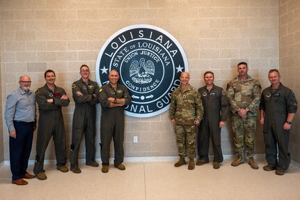 Leadership from the 2nd Bomb Wing, 159th Fighter Wing, Louisiana National Guard and Chennault International Airport pose for a group photo in the National Guard facilities at Chennault International Airport in Lake Charles, La., April 29, 2025. The event brought together senior leaders to assess the utility of Chennault’s infrastructure for future missions and build a framework for more regular collaboration between the 2nd Bomb Wing, 159th Fighter Wing, and Louisiana National Guard. (U.S. Air Force photo by Senior Airman Seth Watson)