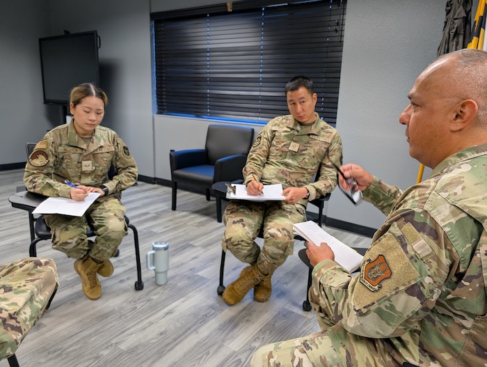Airman and senior leadership sitting together to discuss specific topics.