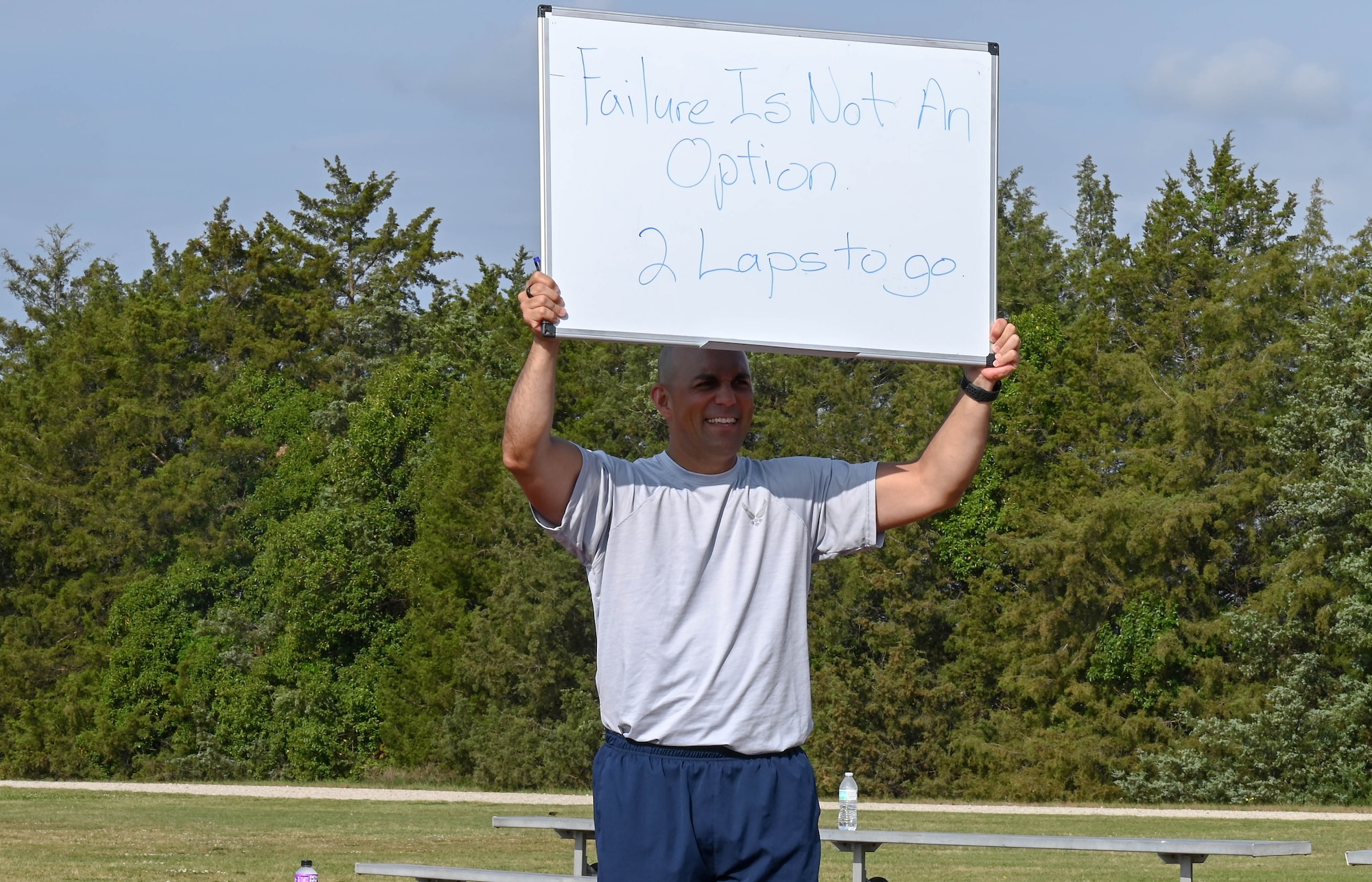 Airman holds sign