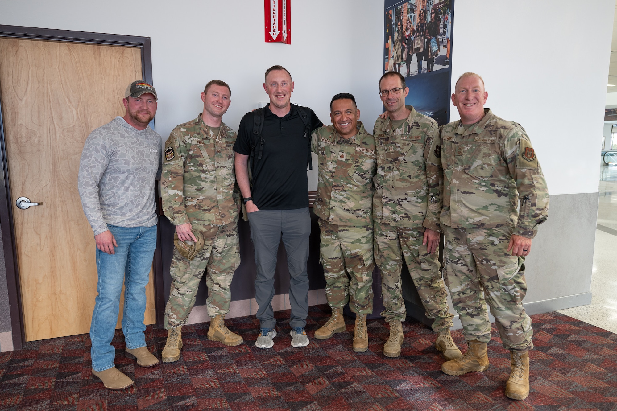 A group of men stand in a row.