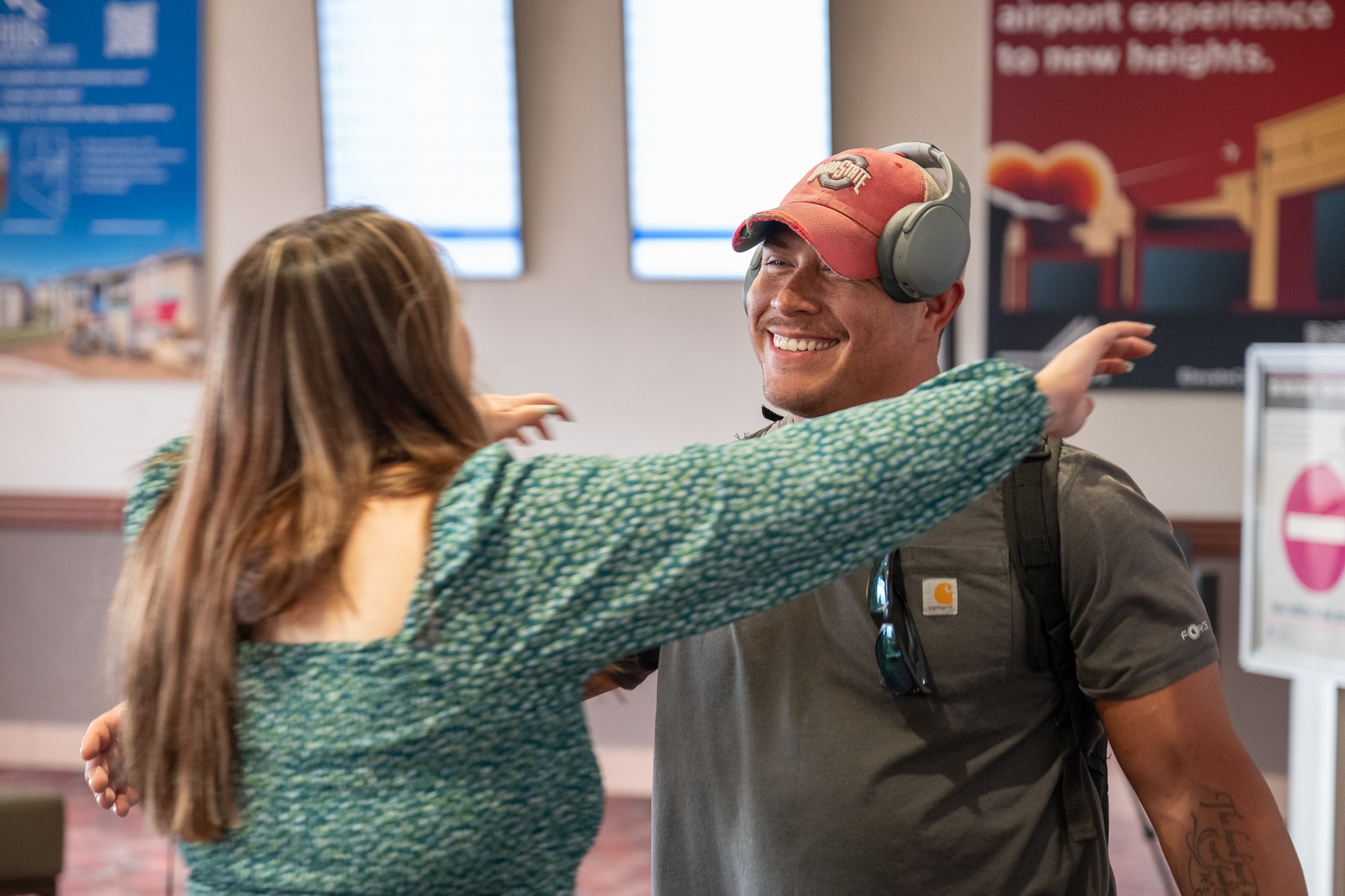 Two people lean in to hug each other.