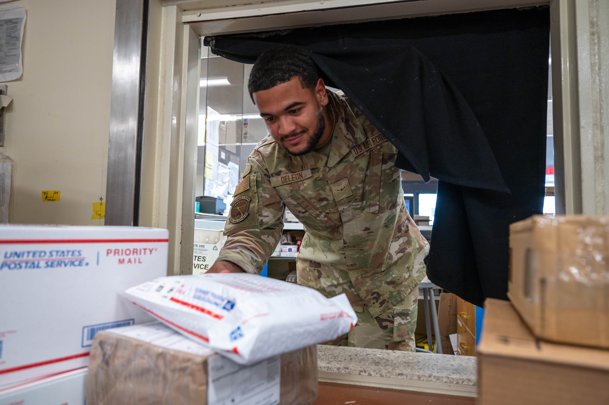 Service member places parcel in the back.