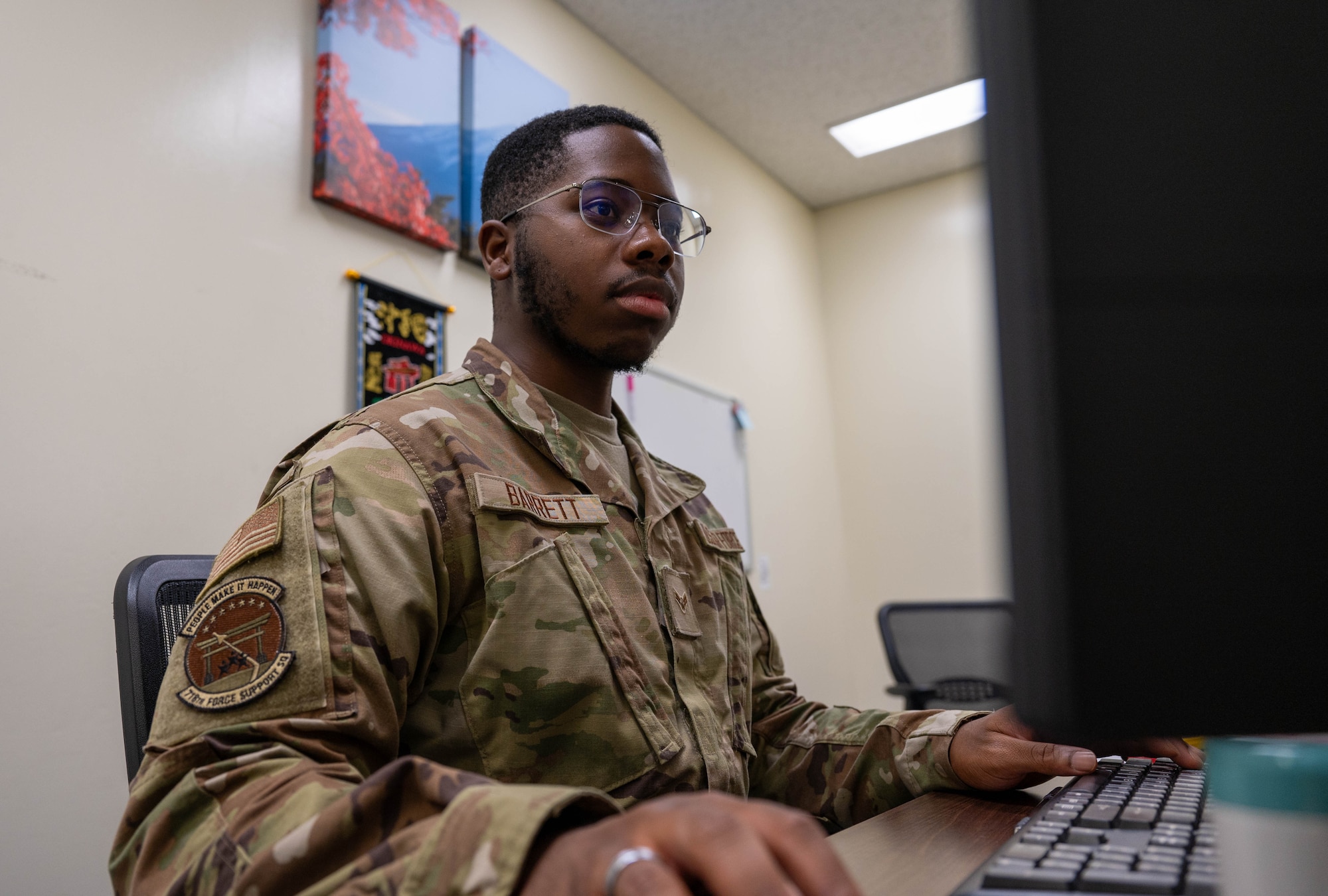 Service member working at desk.