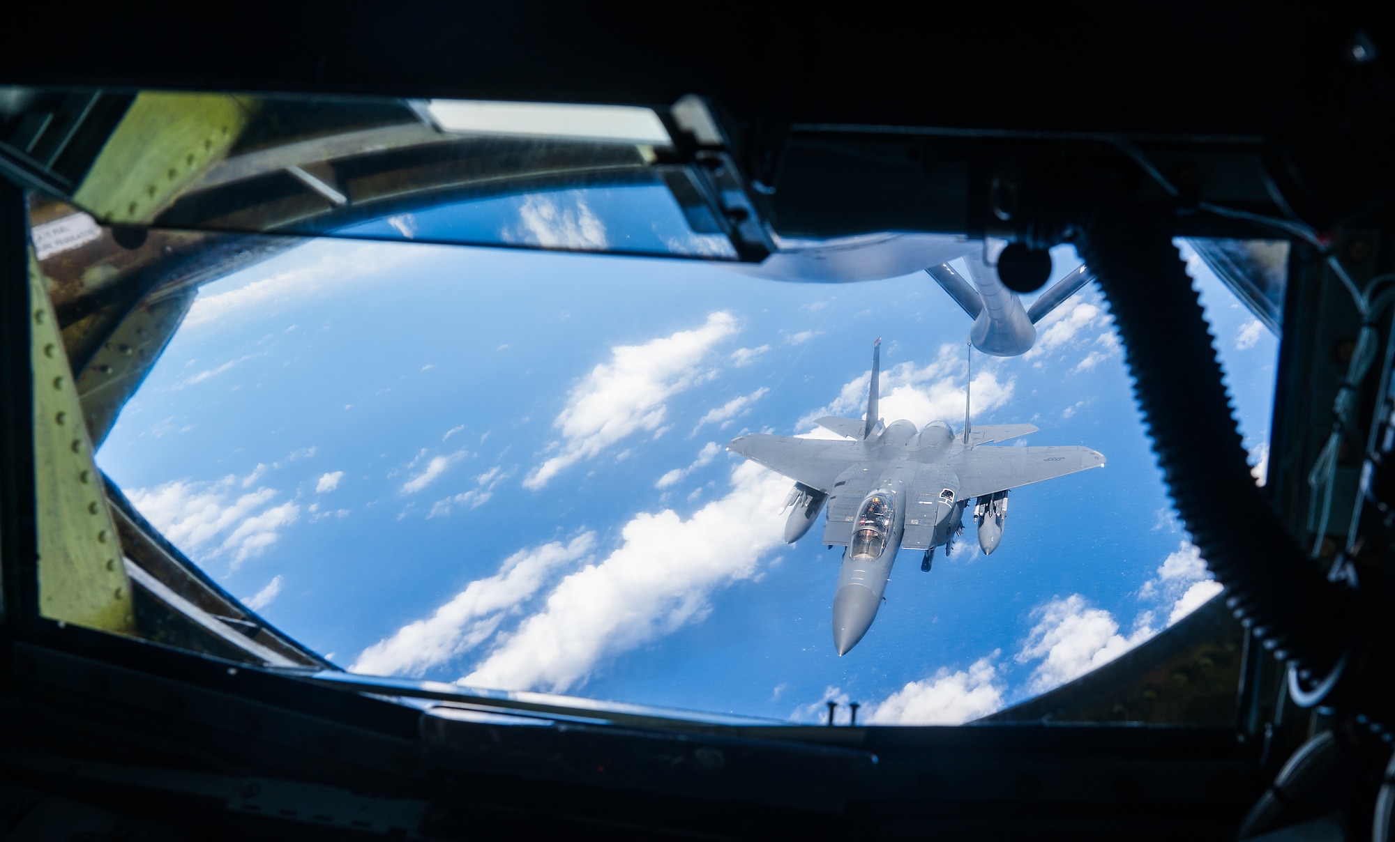 Two U.S. Air Force aircraft perform aerial refueling operations.