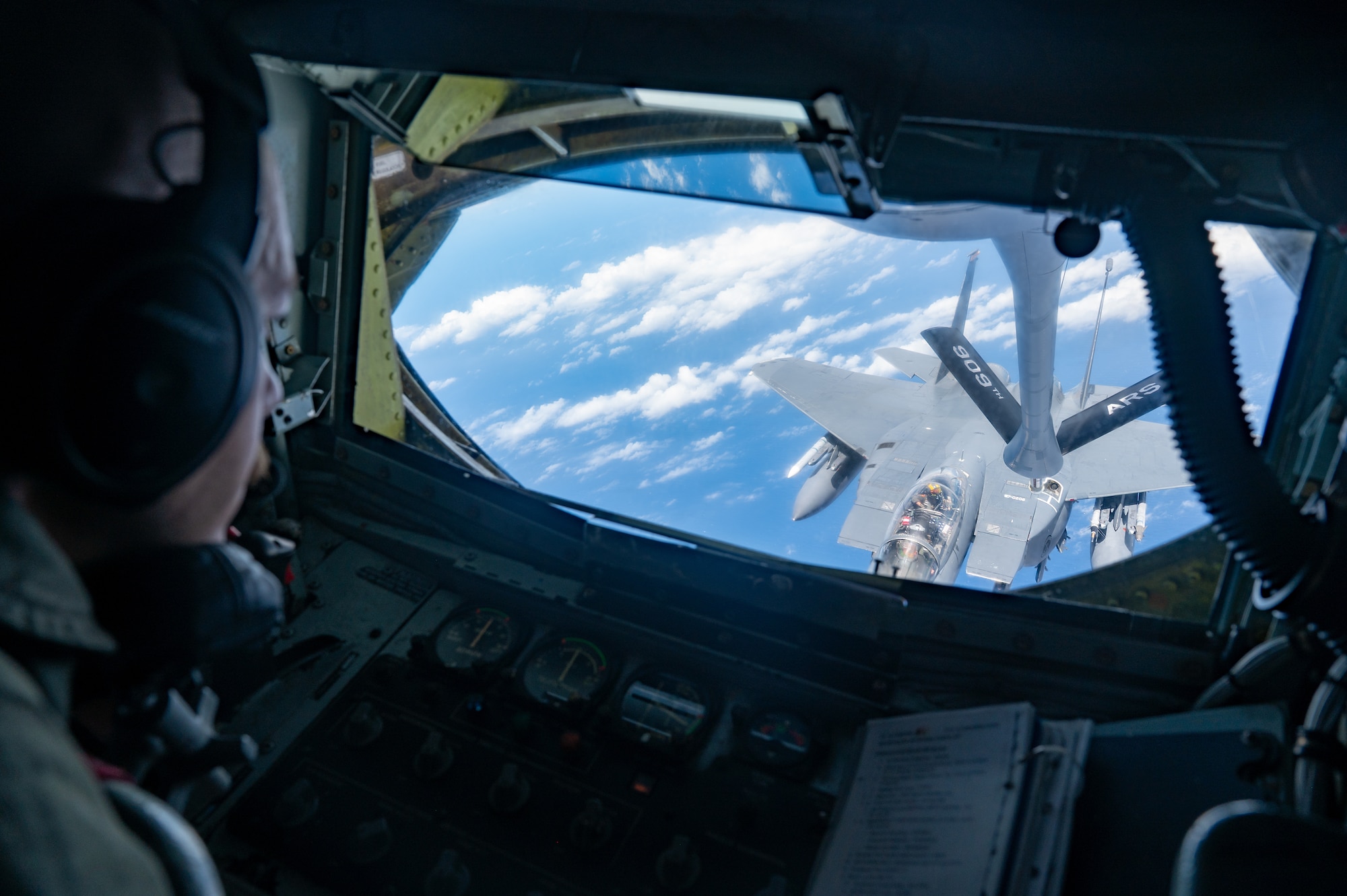 Two U.S. Air Force aircraft perform aerial refueling operations.