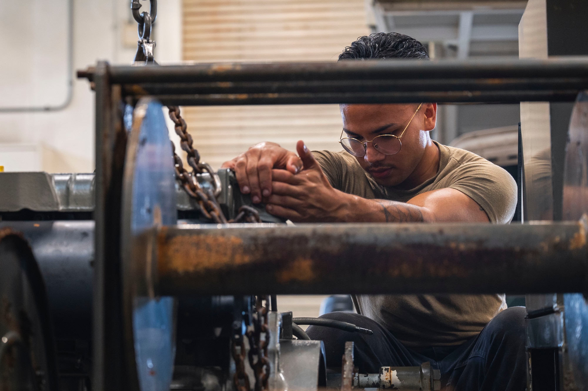 U.S. Air Force Senior Airman Seth Aguon, 18th Logistics Readiness Squadron vehicle maintenance technician, positions an engine on a line trailer at Kadena Air Base, Japan, July 30, 2025.