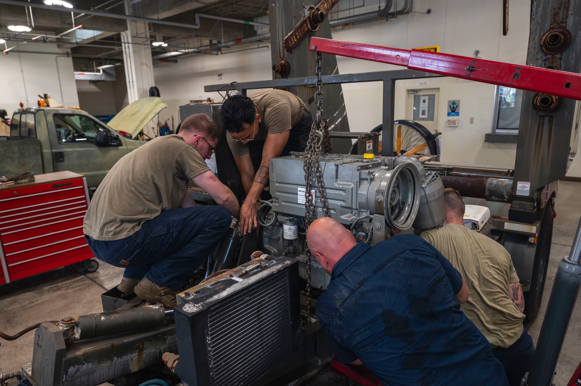 U.S. Air Force Airmen assigned to the 18th Logistics Readiness Squadron attach an engine a line trailer at Kadena Air Base, Japan, July 30, 2025.