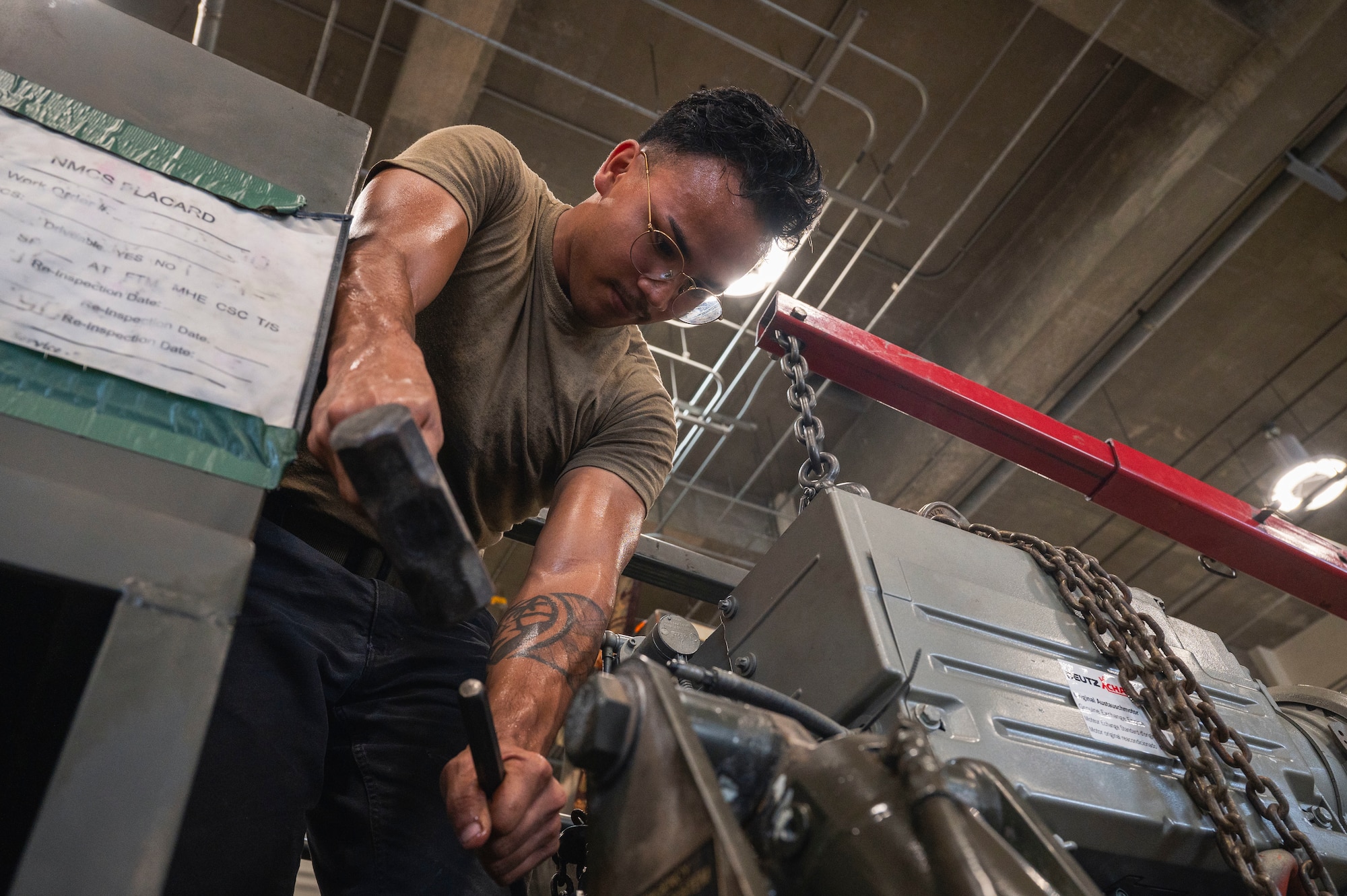 U.S. Air Force Senior Airman Seth Aguon, 18th Logistics Readiness Squadron vehicle maintenance technician, positions an engine on a line trailer at Kadena Air Base, Japan, July 30, 2025.