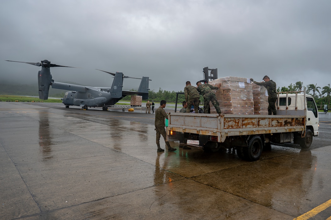 Philippine Marines secure Department of Social Welfare and Development family food packs delivered by CV-22 Ospreys.