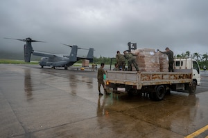Philippine Marines secure Department of Social Welfare and Development family food packs delivered by CV-22 Ospreys.