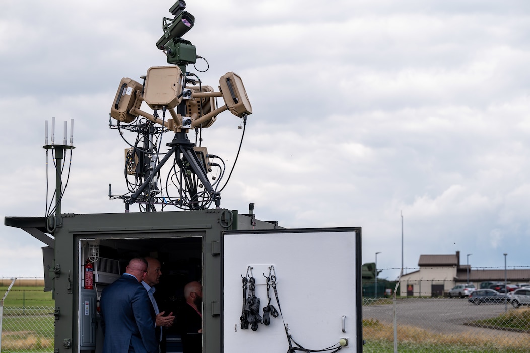 Exterior shot of a group inside a connex box with radar systems on top