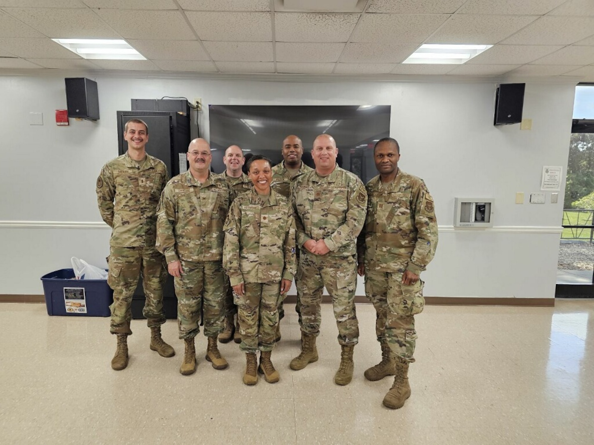 group poses for photo in military uniform