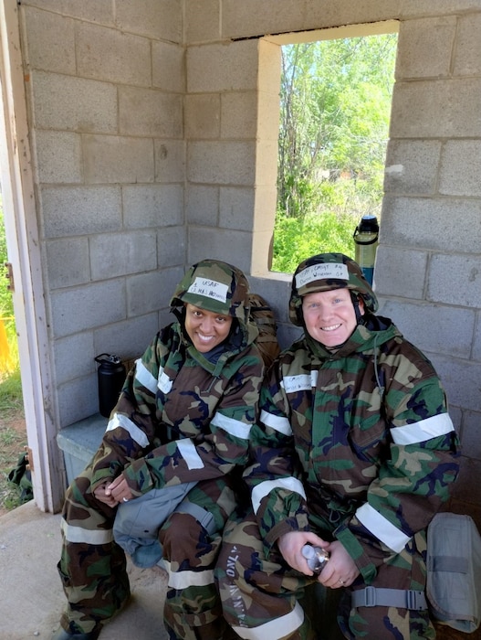 two people pose for photo in military uniform