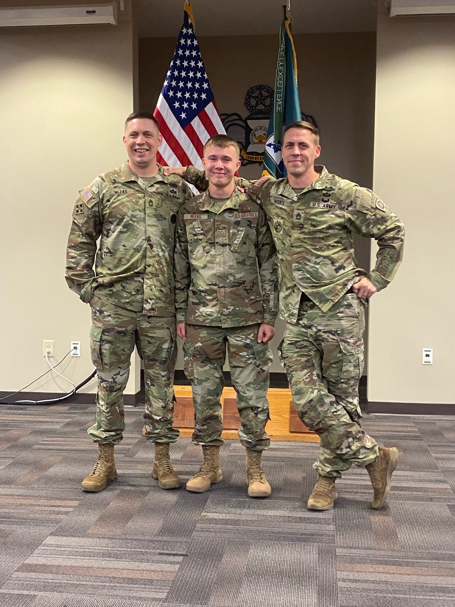 Three service members pose for a photo.
