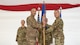 U.S. Air Force Col. Jesse Lamarand, 5th Bomb Wing commander, presents U.S. Air Force Col. Michael McCarthy, 5th Medical Group (5MDG) commander, the guidon during the 5MDG change of command ceremony at Minot Air Force Base, North Dakota, July 31, 2025. The passing of the guidon represents McCarthy’s assumption of command of the 5MDG.