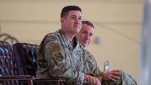U.S. Air Force Col. Shaun Westphal, outgoing 5th Medical Group (5MDG) commander (left), and U.S. Air Force Col. Michael McCarthy (right), incoming 5MDG commander, sit next to each other during the 5MDG change of command ceremony at Minot Air Force Base, North Dakota, July 31, 2025. During the ceremony, Westphal relinquished command to McCarthy.