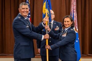 Col Stremmel and Col Malesra holding guidon