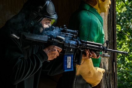 A U.S. Air Force technical sergeant fires simulation rounds from his M4 carbine at the opposition force during a close-quarters combat training exercise at Joint Base Andrews, Md., July 22, 2025.