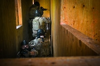 Members from the U.S. Air Force 11th Security Forces Squadron prepare to engage the opposition force during a close-quarters combat training exercise at Joint Base Andrews, Md., July 22, 2025.