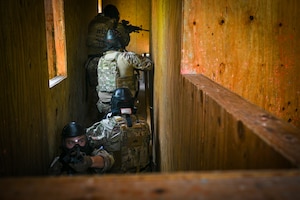 Members from the U.S. Air Force 11th Security Forces Squadron prepare to engage the opposition force during a close-quarters combat training exercise at Joint Base Andrews, Md., July 22, 2025.