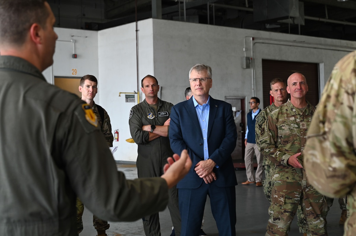 Col. Charles Cooley, 36th Wing commander, briefs Secretary of the Air Force Troy Meink, center, and Chief Master Sgt. of the Air Force David Flosi, right, on 734th Air Mobility Squadron operations at Andersen Air Force Base, Guam, July 27, 2025. The senior leaders visited Andersen AFB to learn more about the Air Force’s first-in-a-generation Department-Level Exercise. (U.S. Air Force photo by Senior Airman Jordan McCoy)