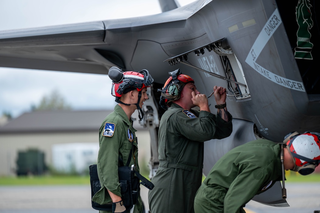 U.S. Marine Corps Marines assigned to Marine Fighter Attack Squadron 121 (VMFA-121) perform maintenance on a F-35B Lightning II during Red Flag-Alaska 25-3 at Eielson Air Force Base, Alaska, July 31, 2025.