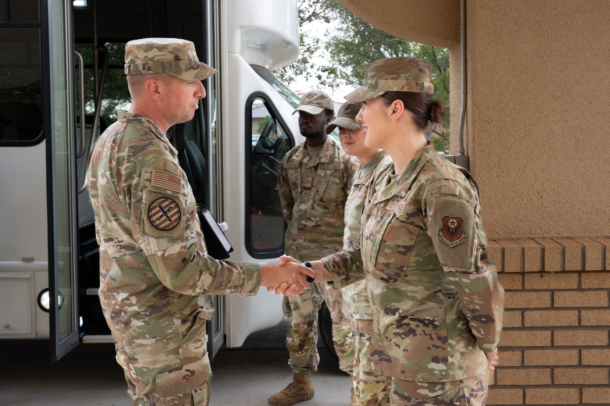 U.S. Air Force Chief Master Sgt. Courtney Freeman, command chief of Air Force Special Operations Command, coins Air Commandos assigned to the 27th Special Operations Wing at Cannon Air Force Base, New Mexico, July 28, 2025. Presenting a challenge coin to an Airman is a gesture of recognition, honoring exceptional performance, dedication and noteworthy accomplishments. (U.S. Air Force photo by Senior Airman Sarah Gottschling)