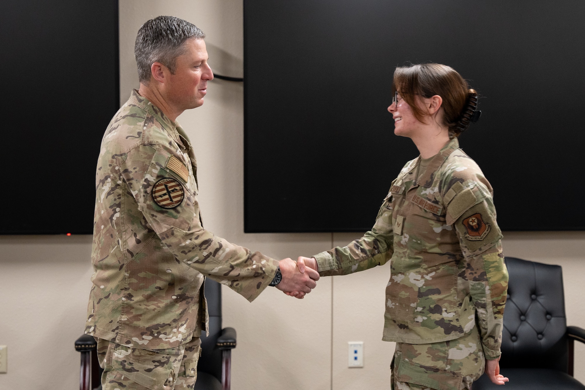 U.S. Air Force Lt. Gen. Michael Conley, commander of Air Force Special Operations Command, coins an Air Commando assigned to the 27th Special Operations Wing at Cannon Air Force Base, New Mexico, July 29, 2025. Air Commandos were honored for their achievements across the base, demonstrating support for their team and commitment to holding the line. (U.S. Air Force photo by Senior Airman Sarah Gottschling)