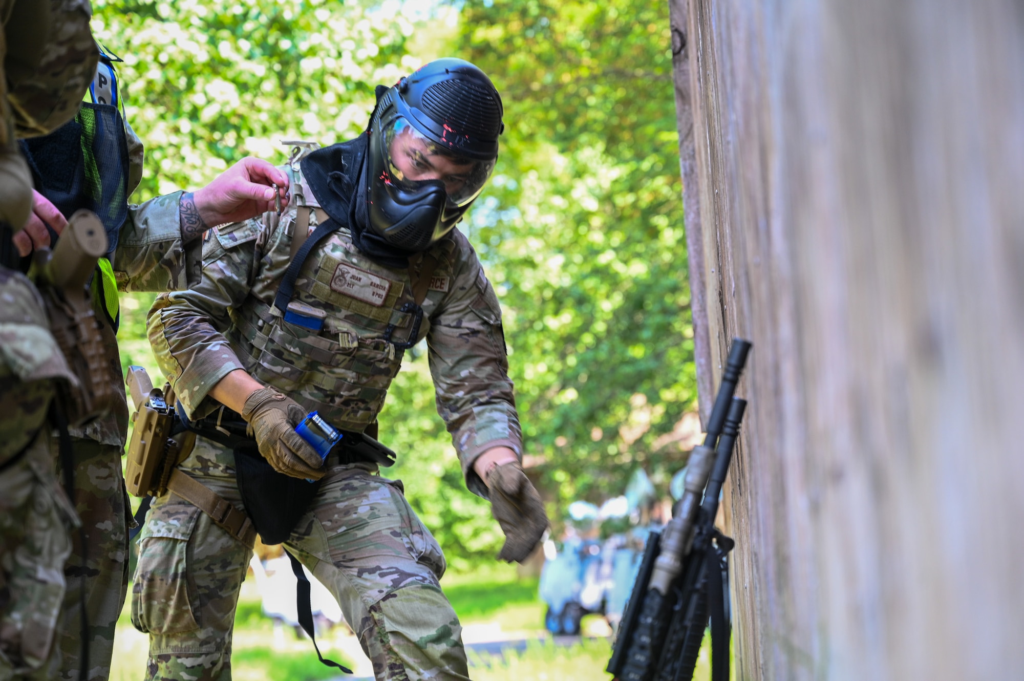 U.S. Air Force 2nd Lt. Juan Garcia, a flight commander for the U.S. Air Force 11th Security Forces Squadron, Joint Base Anacostia-Bolling, Washington, D.C., reaches for his M4 carbine during a close-quarters combat training exercise at Joint Base Andrews, Md., July 22, 2025. The exercise featured security forces members utilizing M4 carbines for close-quarters combat scenarios. (U.S. Air Force photo by Airman 1st Class Shanel Toussaint)