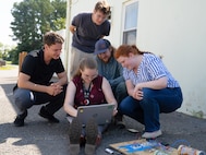 DAHLGREN, Va. – Rose Stanphill, a flight systems modeling engineer at Naval Surface Warfare Center Dahlgren Division (NSWCDD), watches a computer screen to see whether the low-budget coffee can radar she and her team produced during a Workforce Development Innovation Challenge is working. She was joined by her NSWCDD teammates, left to right: Zach Strimling, software developer; Trevor Acosta, optics/photonics engineer; William Urbanic, mechanical engineer and Abigail Thompson, optomechanical engineer (NSWCDD). (Tierney Kunstmann/NSWCDD Photo)