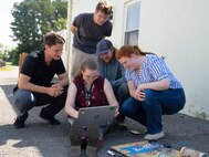 DAHLGREN, Va. – Rose Stanphill, a flight systems modeling engineer at Naval Surface Warfare Center Dahlgren Division (NSWCDD), watches a computer screen to see whether the low-budget coffee can radar she and her team produced during a Workforce Development Innovation Challenge is working. She was joined by her NSWCDD teammates, left to right: Zach Strimling, software developer; Trevor Acosta, optics/photonics engineer; William Urbanic, mechanical engineer and Abigail Thompson, optomechanical engineer (NSWCDD). (Tierney Kunstmann/NSWCDD Photo)