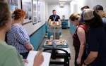 DAHLGREN, Va. – Derek Diltz (center), chief engineer in the High Power Microwave Weapon Systems Division at Naval Surface Warfare Center Dahlgren Division, tests a low-budget coffee can radar produced by a group of early career scientists and engineers during a Workforce Development Innovation Challenge. (Tierney Kunstmann/NSWCDD Photo)