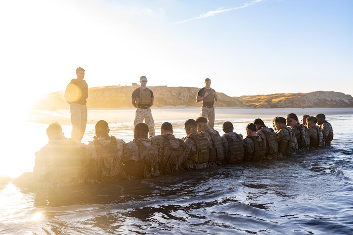 U.S. Marines with 1st Reconnaissance Battalion, 1st Marine Division, do squad sit-ups during the Martial Arts Instructor Course 99-25 culminating event at Marine Corps Base Camp Pendleton, California, July 9, 2025. Marines attend MAI courses to develop the skills, knowledge, and resilience required to instruct and certify Marines through the Marine Corps Martial Arts Program, enhancing their unit’s combat effectiveness and physical readiness. (U.S. Marine Corps photo by Lance Cpl. Jonathan Sherchand)