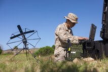 U.S. Marine Corps Cpl. Victorino Betancourtfarias, a transmissions systems operator with Headquarters Battalion, 1st Marine Division, utilizes a radio during the annual division communications competition at Marine Corps Base Camp Pendleton, California, June 17, 2025. The competition brought together communications Marines from across the division to evaluate their technical expertise and application of communications gear and principles. Betancourtfarias is a native of California. (U.S. Marine Corps photo by Lance Cpl. Earik Barton)