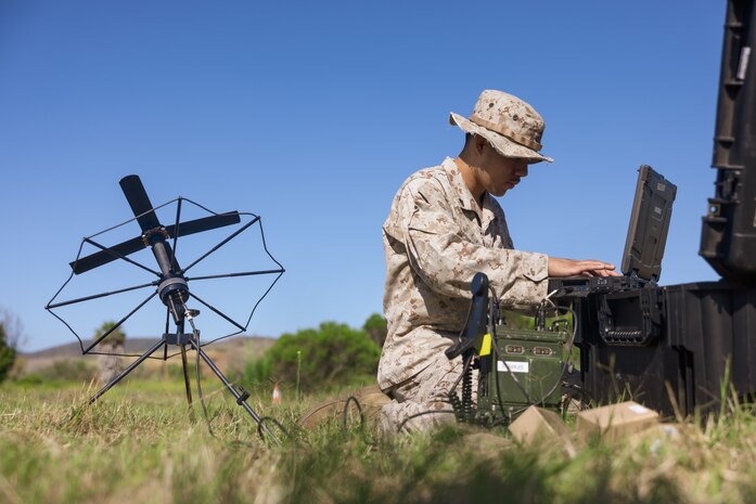 U.S. Marine Corps Cpl. Victorino Betancourtfarias, a transmissions systems operator with Headquarters Battalion, 1st Marine Division, utilizes a radio during the annual division communications competition at Marine Corps Base Camp Pendleton, California, June 17, 2025. The competition brought together communications Marines from across the division to evaluate their technical expertise and application of communications gear and principles. Betancourtfarias is a native of California. (U.S. Marine Corps photo by Lance Cpl. Earik Barton)
