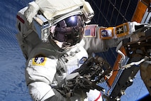 COL Anne McClain works near one of the International Space Station’s main solar arrays during a spacewalk. May 1, 2025