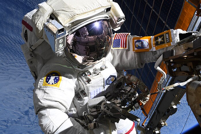 COL Anne McClain works near one of the International Space Station’s main solar arrays during a spacewalk. May 1, 2025