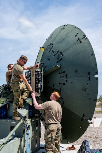 Airmen adjust an antenna