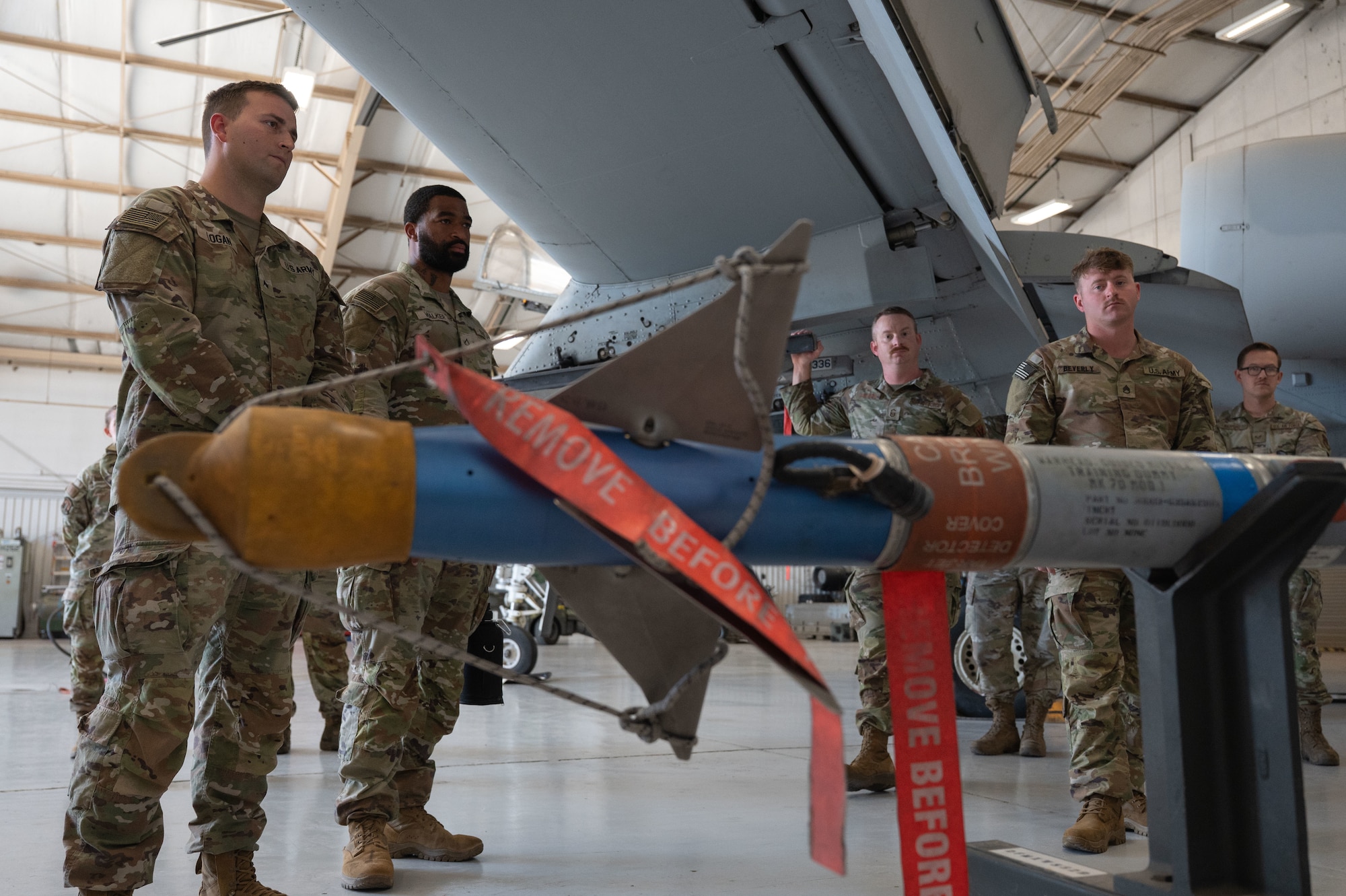 U.S. Army soldiers assigned to the 12th Infantry Regiment learn about the AIM-9 Sidewinder at Davis-Monthan Air Force Base, Arizona, July 25, 2025. The AIM-9 Sidewinder is an air-to-air missile equipped with a high-explosive warhead and an infrared heat-seeking guidance system. (U.S. Air Force photo by Airman Jaden Kidd)