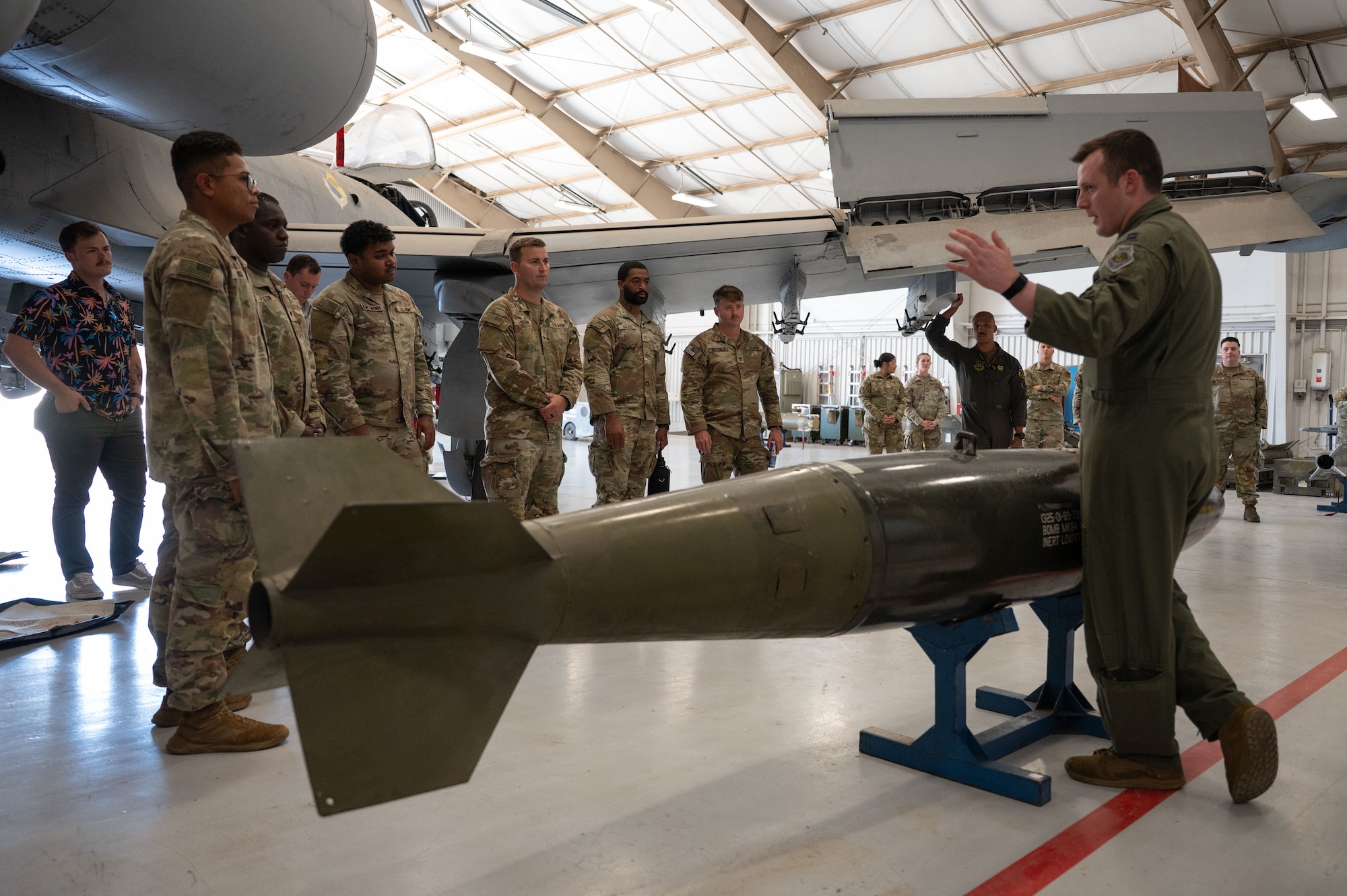 U.S. Air Force Capt. Dylan “Nerd” Smith, 357th Fighter Squadron chief of weapons and tactics, teaches U.S. Army soldiers from the 12th Infantry Regiment about the Mark 84 general purpose bomb at Davis-Monthan Air Force Base, Arizona, July 25, 2025. The MK84 was a free-fall bomb, relying on gravity to reach its target. (U.S. Air Force photo by Airman Jaden Kidd)