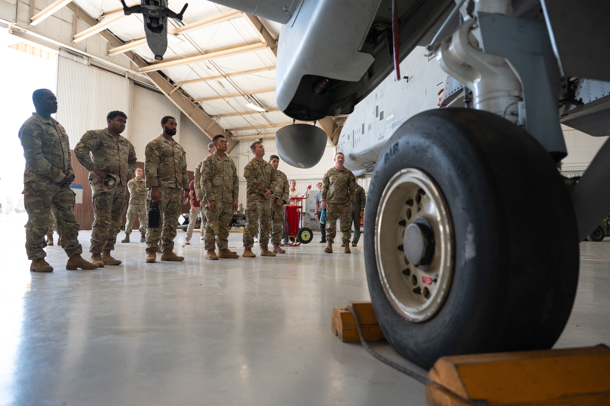 U.S. Army soldiers from the 12th Infantry Regiment learn about the A-10C Thunderbolt II aircraft at Davis-Monthan Air Force Base, Arizona, July 25, 2025. The A-10C Thunderbolt II was the first U.S. Air Force aircraft specifically designed for close air support of ground forces. (U.S. Air Force photo by Airman Jaden Kidd)