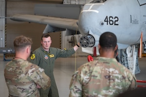 U.S. Air Force Capt. Dylan “Nerd” Smith, 357th Fighter Squadron chief of weapons and tactics, teaches U.S. Army soldiers about the 30 mm GAU-8/A Gatling gun on the A-10C Thunderbolt II at Davis-Monthan Air Force Base, Arizona, July 25, 2025. The Gatling gun was able to fire 3,900 rounds per minute to defeat ground targets. (U.S. Air Force photo by Airman Jaden Kidd)