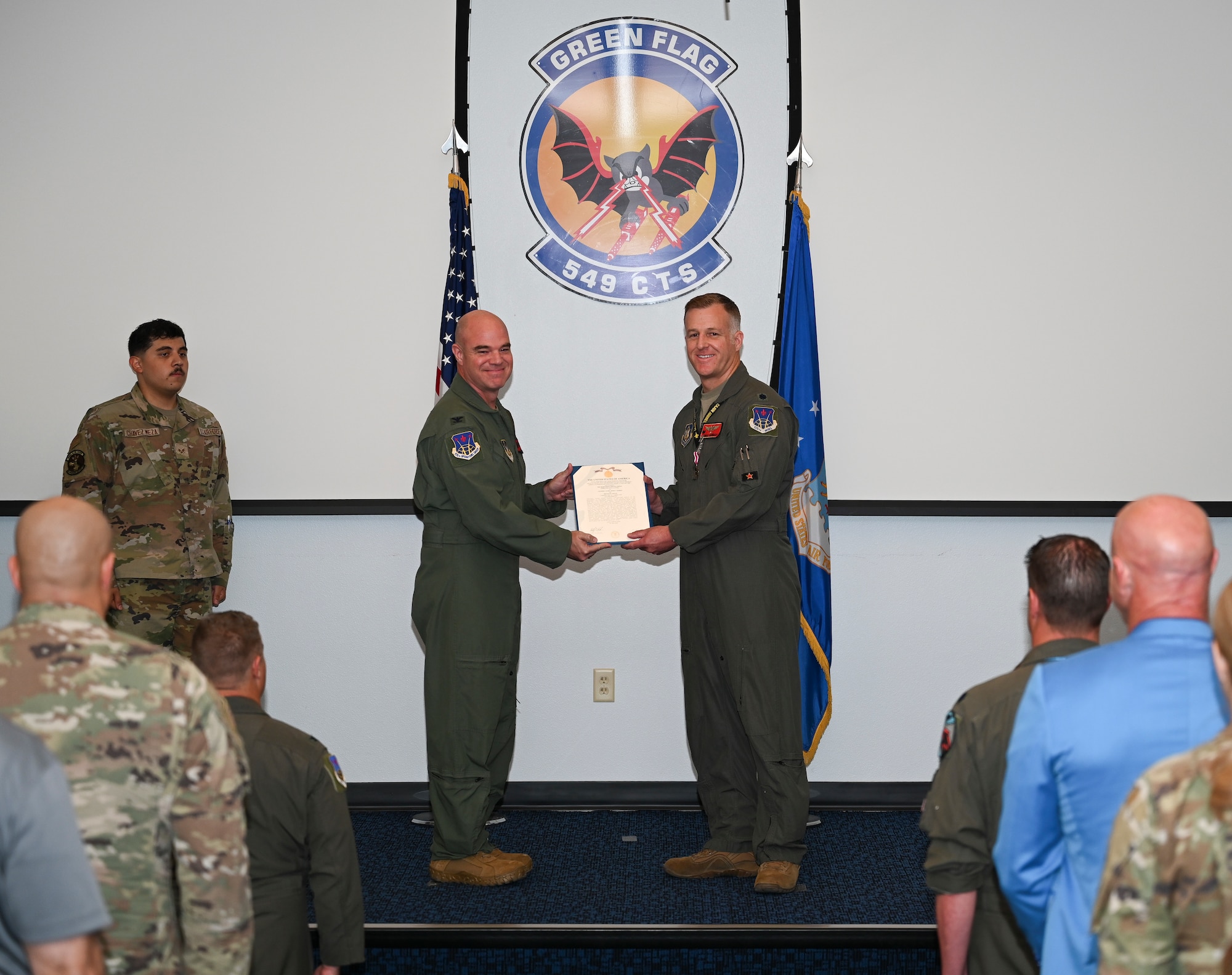 U.S. Air Force Lt. Col. Andrew W. Baumgart, outgoing 706th Aggressor Squadron (AGRS) commander, relinquished command to Lt. Col. Kristin L. Hollrith, incoming 706th AGRS commander, during a change of command ceremony at Nellis Air Force Base, Nevada, August 1, 2025.