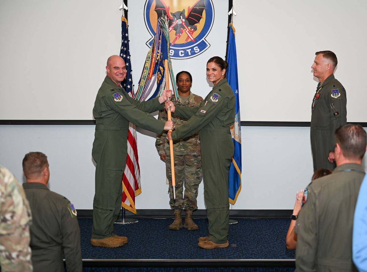 U.S. Air Force Lt. Col. Andrew W. Baumgart, outgoing 706th Aggressor Squadron (AGRS) commander, relinquished command to Lt. Col. Kristin L. Hollrith, incoming 706th AGRS commander, during a change of command ceremony at Nellis Air Force Base, Nevada, August 1, 2025.