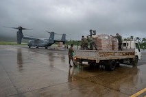 Philippine Marines secure Department of Social Welfare and Development family food packs delivered by CV-22 Ospreys.