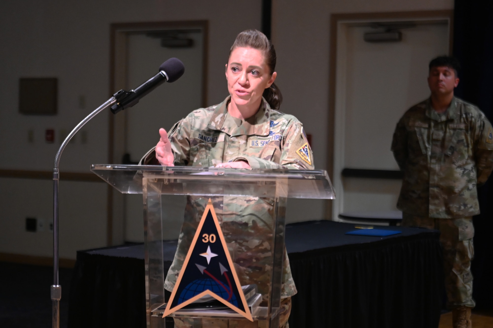 a person stands at a podium and speaks on stage